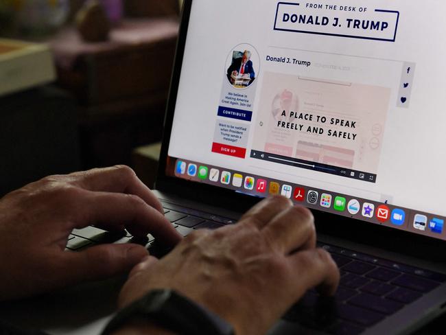 A woman looks at former US President Donald Trump's new social media platform 