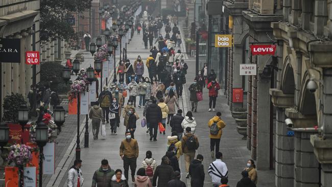 People walk along a pedestrian street in Wuhan, China's central Hubei province, one year after the city went into lockdown to curb the spread of Covid-19. Picture: AFP