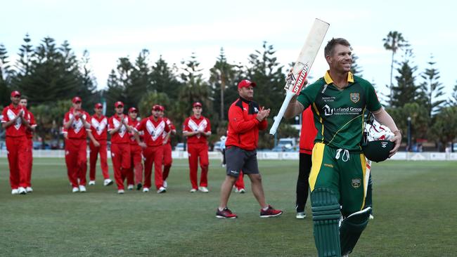 David Warner all smiles as he leads the teams off Coogee Oval. Photo by Ryan Pierse/Getty Images