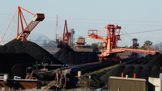 Stackers and reclaimers operate next to stockpiles of coal at the Newcastle Coal Terminal in Newcastle.