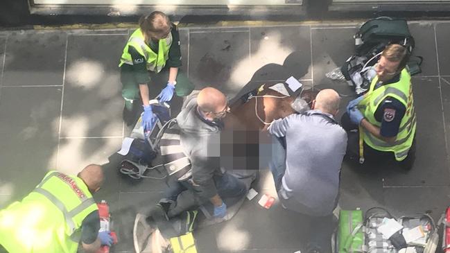 Paramedics treat the attacker Picture: Josh Fagan