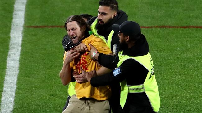 SYDNEY, AUSTRALIA - OCTOBER 02: A pitch invader is apprehended by security staff during the 2022 NRL Grand Final match between the Penrith Panthers and the Parramatta Eels at Accor Stadium on October 02, 2022 in Sydney, Australia. (Photo by Jason McCawley/Getty Images)