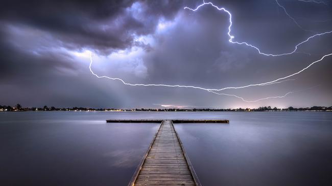 Lightning bolts light up a lake. Picture: Jarrod Andrews.