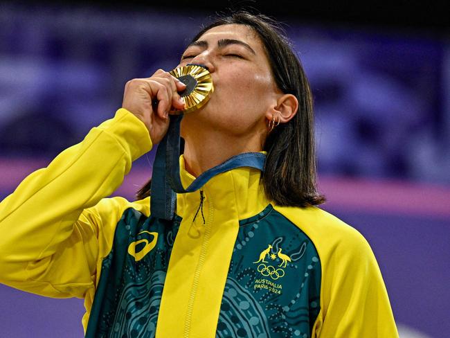 Saya Sakakibara kisses her gold medal standing on the podium after winning the Women's Cycling BMX Racing finals. Picture: Julien De Rosa / AFP