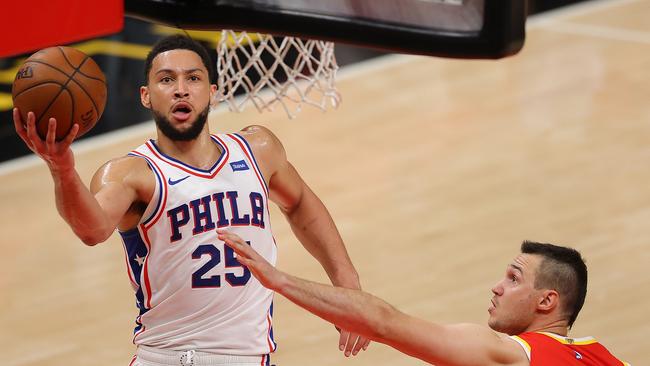 ATLANTA, GEORGIA - JUNE 11:  Ben Simmons #25 of the Philadelphia 76ers drives against Danilo Gallinari #8 of the Atlanta Hawks during the first half of game 3 of the Eastern Conference Semifinals at State Farm Arena on June 11, 2021 in Atlanta, Georgia.  NOTE TO USER: User expressly acknowledges and agrees that, by downloading and or using this photograph, User is consenting to the terms and conditions of the Getty Images License Agreement. (Photo by Kevin C. Cox/Getty Images)