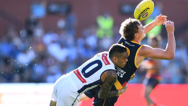 Jordan Dawson of the Crows tackled by Michael Walters of the Dockers