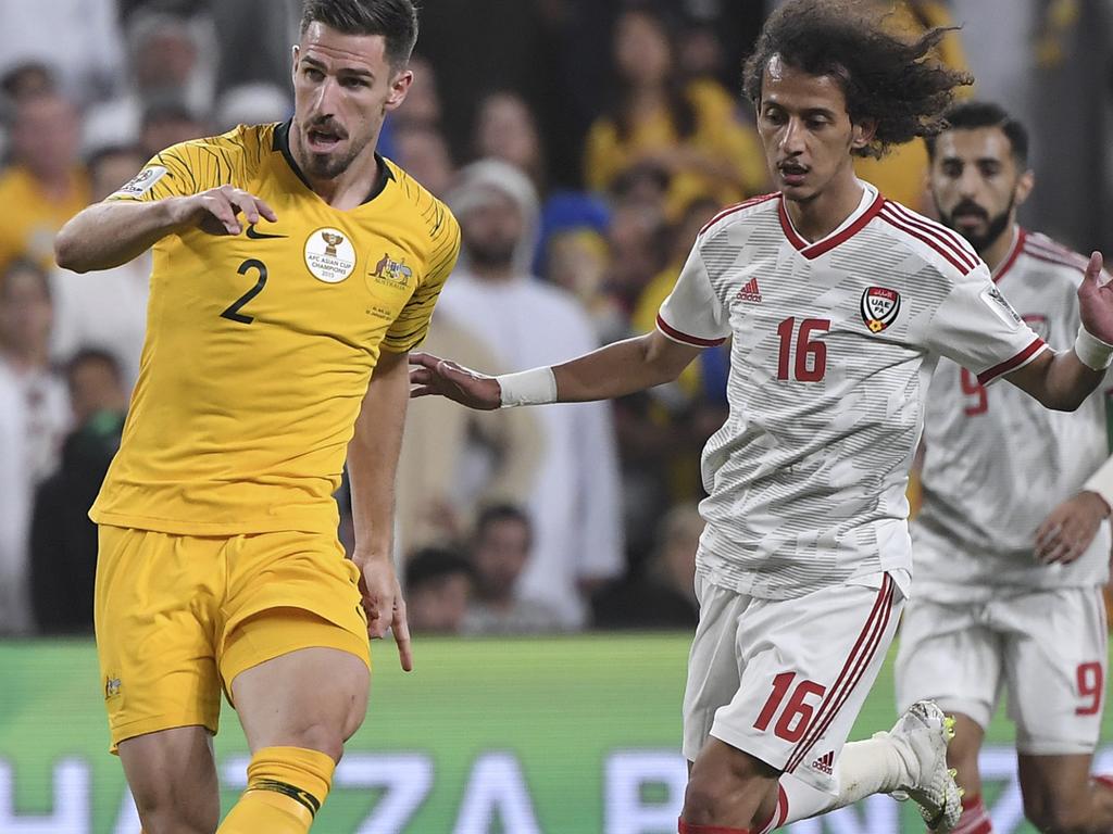 Australia's defender Milos Degenek, left, makes a wrong pass to his goalkeeper Mat Ryan as United Arab Emirates' midfielder Mohammed Abdulrah, right, looks on during the AFC Asian Cup quarterfinal soccer match between United Arab Emirates and Australia at Hazza Bin Zayed Stadium in Al Ain, United Arab Emirates, Friday, Jan. 25, 2019. (AP Photo/Hassan Ammar)