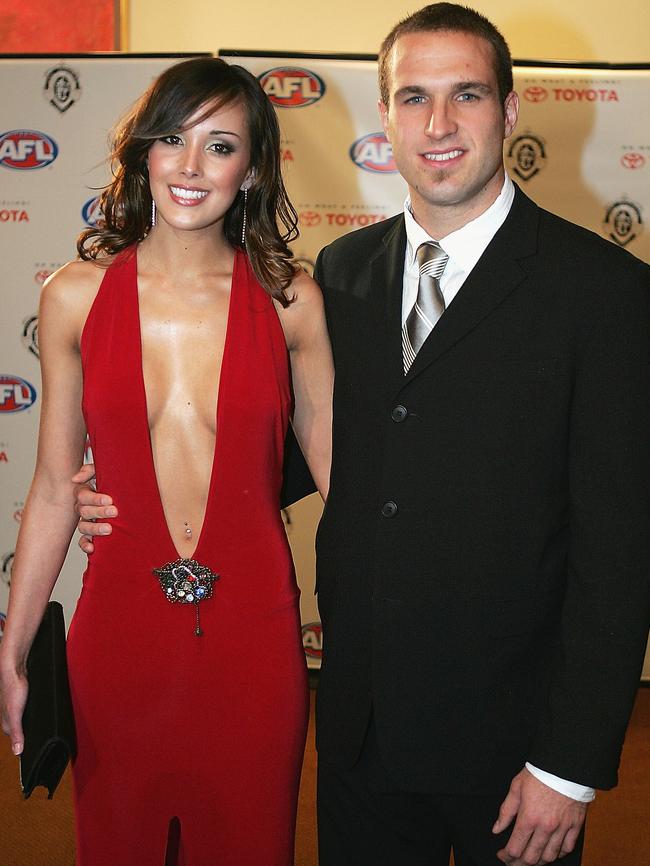 Rebecca Twigley-now-Judd in THAT red dress, with dual Brownlow Medallist Chris Judd. Picture: Getty Images