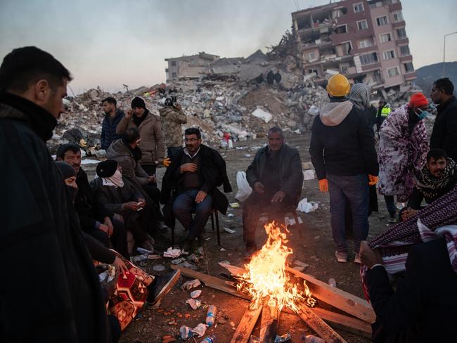 People wait for news of their loved ones, believed to be trapped under collapsed buildings in Hatay. Picture: AFP