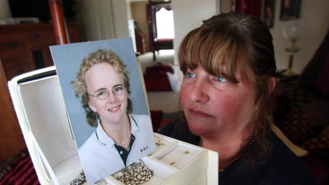 Krystal Fraser’s mother Karen looks at a photo of her daughter.