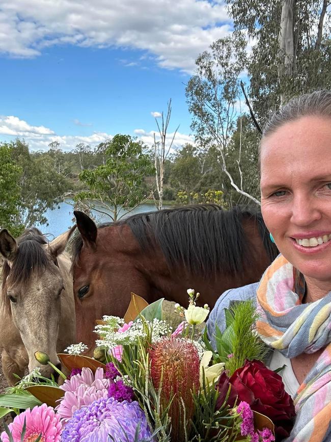 Natalie Hatton with flowers grown at her home at Mount Lawless.