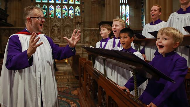 Conductor Ross Cobb with the St Andrew's Cathedral Choir at St Andrew's Cathedral in Sydney’s CBD this morning. Picture: Justin Lloyd.