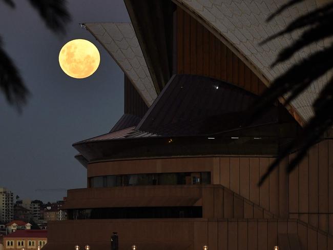 The Moon rises over the Opera House in Sydney on May 26, 2021, ahead of a total lunar eclipse as stargazers across the Pacific are casting their eyes skyward to witness a rare 