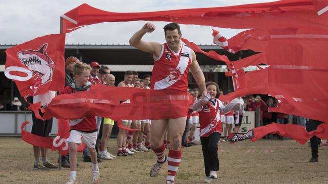 Sorrento footballer Guy Stringer plays 400th senior game. Guy Stringer with son Archie, 9 and Olivia, 5, running through the banner. Tyabb (dark) vs Sorrento (light) at Bunguyan Reserve. Photo taken on the 25th of July, 2015. Photo Christopher Chan.