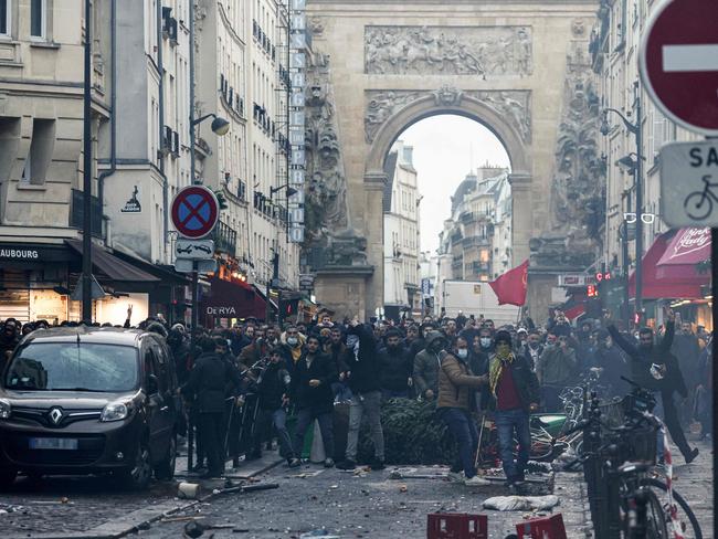 Protesters stand in front of riot police officers after the Paris shooting. Picture: AFP