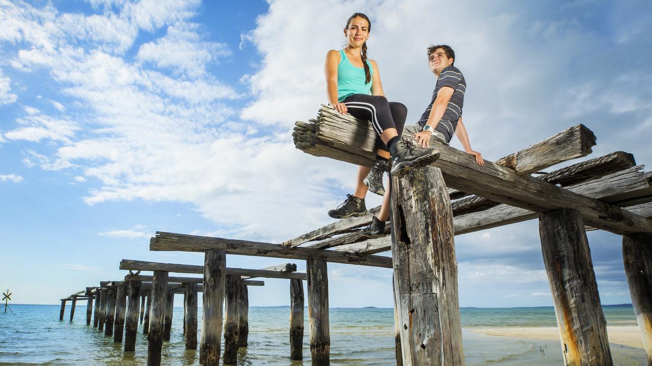 Tourists Tess Schreck and Jamen Gallagher at McKenzies Jetty on Fraser Island are excited Prince Harry and Meghan Markle will be visiting the World Heritage listed site. Picture: Lachie Millard