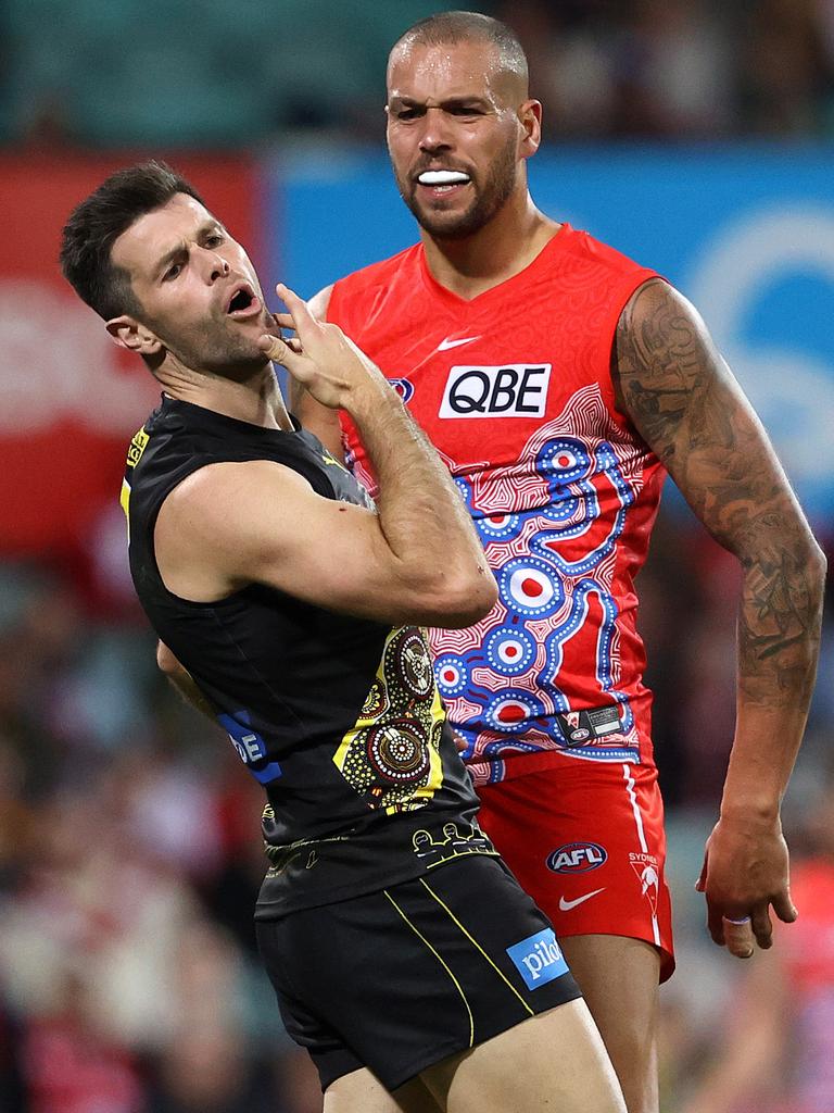 Cotchin grabs at his jaw.