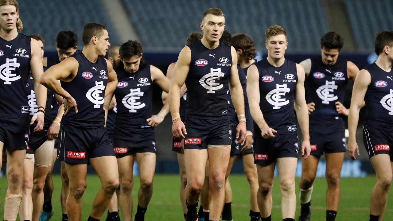 MELBOURNE, AUSTRALIA - JULY 24: The Blues look dejected after a loss during the 2021 AFL Round 19 match between the Carlton Blues and the North Melbourne Kangaroos at Marvel Stadium on July 24, 2021 in Melbourne, Australia. (Photo by Michael Willson/AFL Photos via Getty Images)