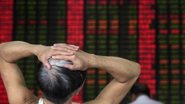 To go with China-economy-stocks-policy,FOCUS by Bill SAVADOVE In this photo taken on September 1, 2015, an investor reacts in front of a digital board showing stock market movements at a brokerage house in Shanghai. Chinese authorities have deployed vast sums to try to stabilise slumping share prices, but have to contend with a rumour-driven market and investors like Wang Youfu, whose latest sure thing is a chemical firm that lost $180 million last year. AFP PHOTO / JOHANNES EISELE