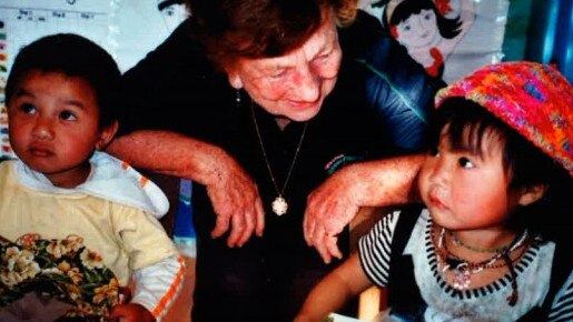 Mary Hartle with children who received their Christmas gifts.