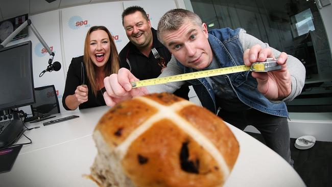 Cripps CEO Paul Gadonski, centre, with breakfast radio hosts Paul and Woody who have started a campaign to make the world's largest hot cross bun.