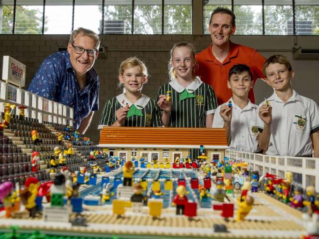 Lego Masters contestants, Andrew Tuppen and Damian Hinds, have built a lego model of the soon to be built Junior Aquatic Centre at Trinity Lutheran College. They are pictured with students Meeka, Anais, Jackson and Leo. Picture: Jerad Williams