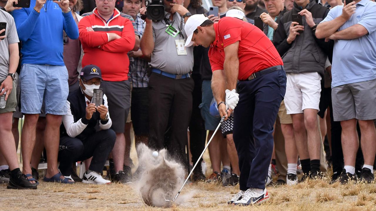 US player Patrick Reed hits out of the rough at Royal Melbourne.
