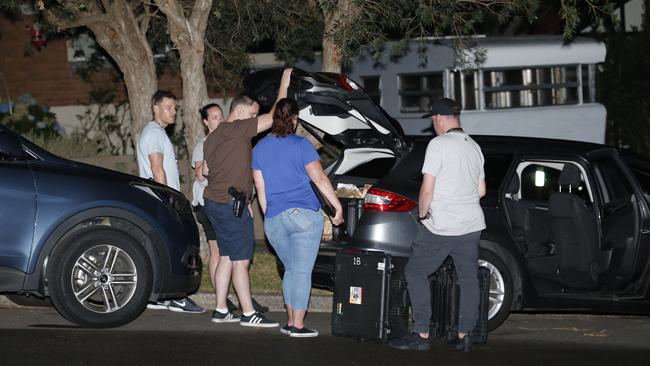 Detectives and police pack evidence into a vehicle after a police operation in Bexley. Picture: Steve Tyson