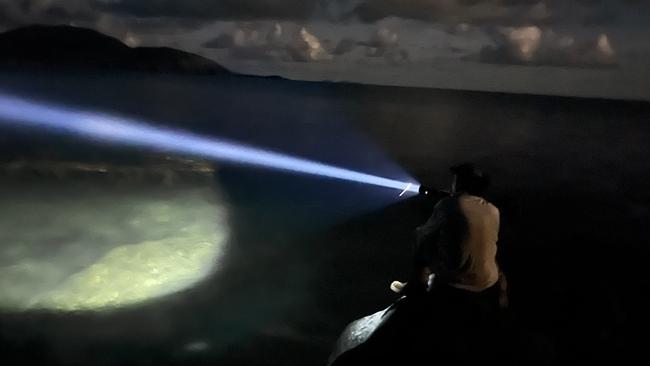 Wildlife officers conduct spotlight searches for the shining eyes of any crocodiles in the Archer Point area. Picture: DES