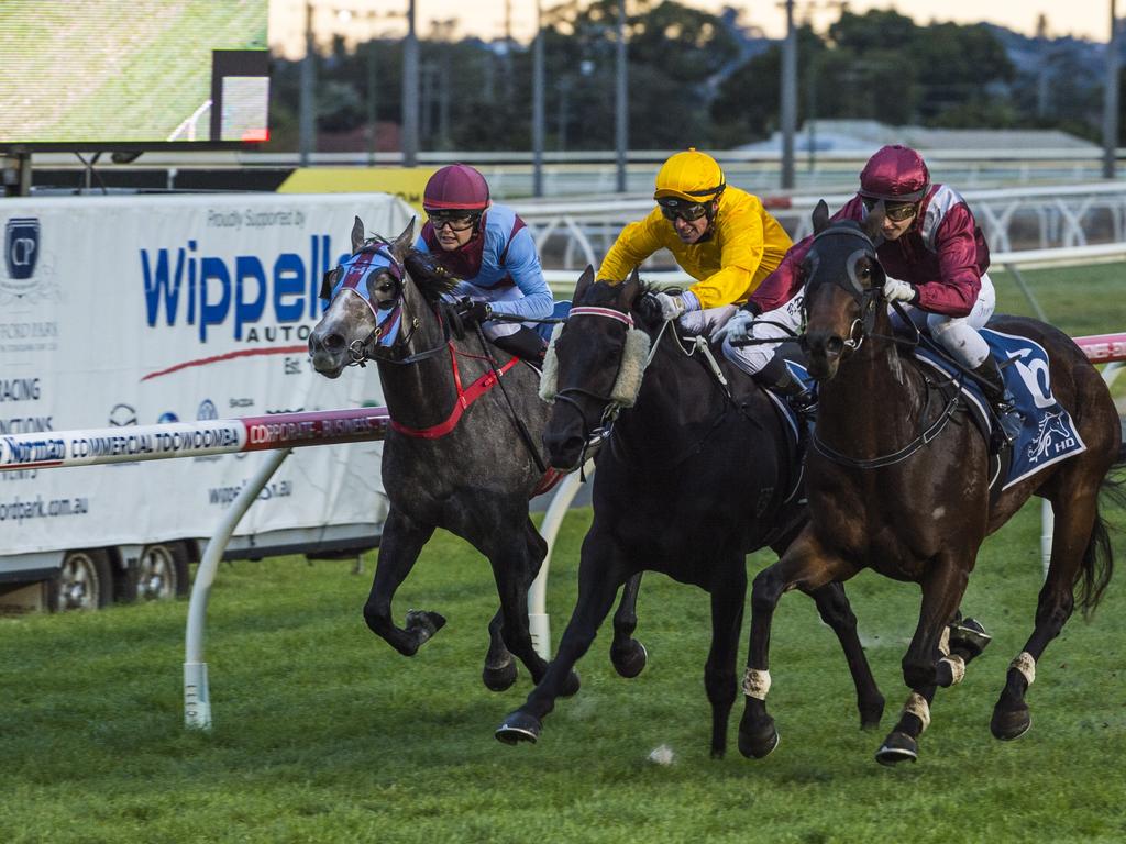 Jockey Alannah Fancourt guides Chevrons'n'rockers (outside) to win race one at Clifford Park Racecourse, Saturday, June 19, 2021. Picture: Kevin Farmer