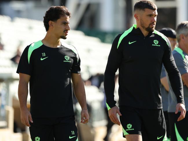 Socceroos pair Daniel Arzani (left) and Mat Ryan are preparing to face Saudi Arabia in Jeddah on Wednesday morning. Picture: Paul Kane/Getty Images