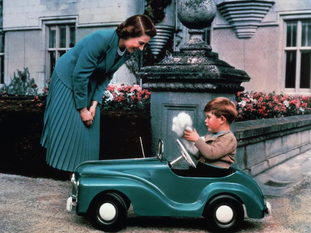 1952: Queen Elizabeth watches her son Prince Charles driving in a toy car on the grounds of Balmoral Castle. Picture: Hulton-Deutsch Collection/Corbis via Getty Images