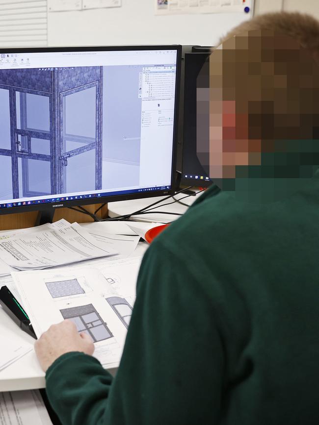 An inmate works with a CAD drawing on a PC as he designs a toilet for the jail. Picture: Sam Ruttyn