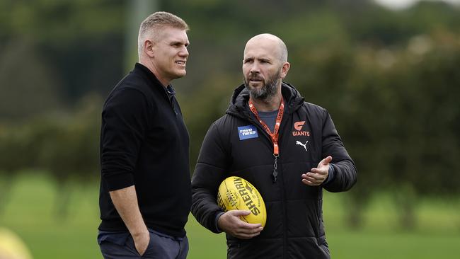 Giants interim coach Mark McVeigh, pictured right speaking to football boss Jason McCartney, wants to keep the job for next season. Picture: Phil Hillyard