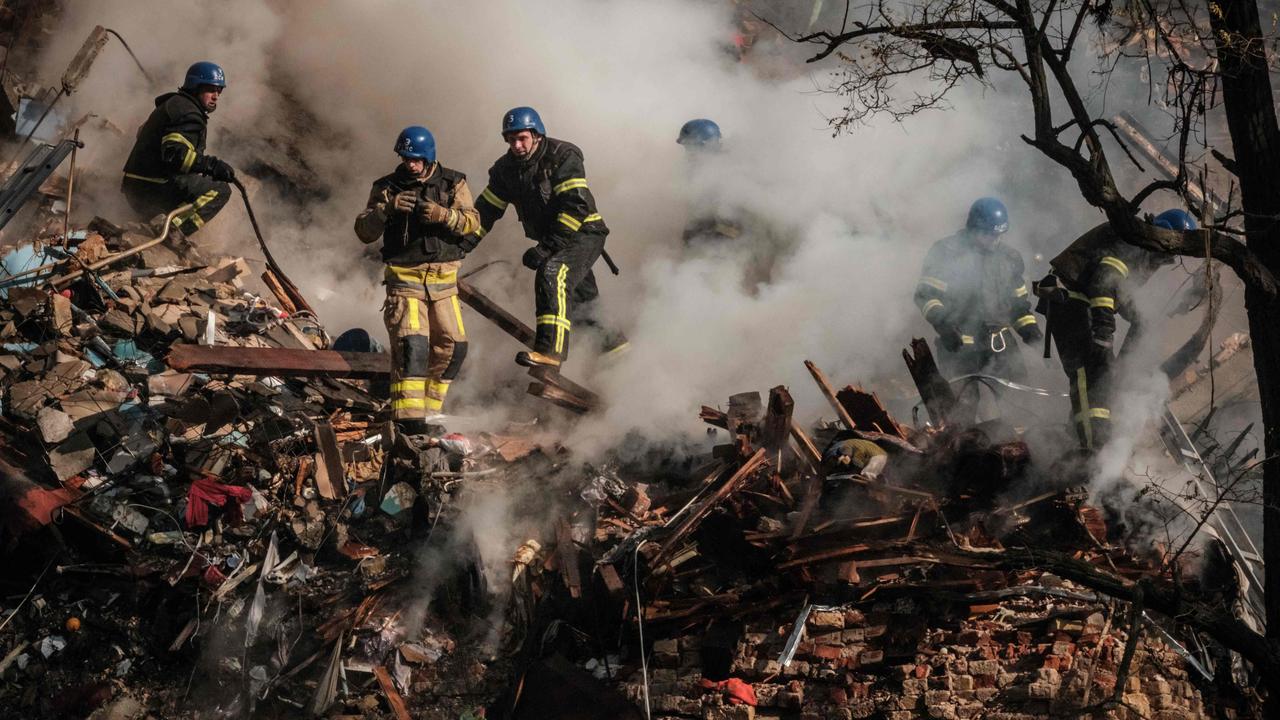 Ukrainian firefighters works on a destroyed building after a drone attack in Kyiv on October 17, 2022. Picture: AFP