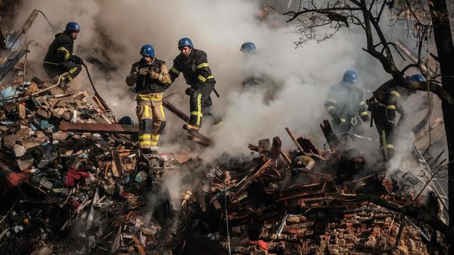 Ukrainian firefighters works on a destroyed building after a drone attack in Kyiv on October 17, 2022. Picture: AFP