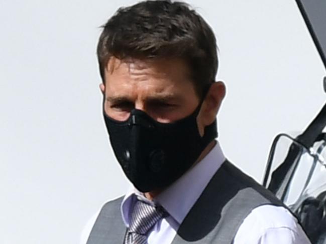 US actor Tom Cruise (L), wearing a face mask, is pictured on the set during the filming of 