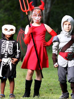 Queensland kids Itayi, Emma and Mason all dressed up. Picture: AAP/Steve Pohlner