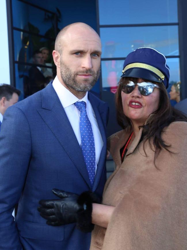 Chris Judd didn’t look all that comfortable when posing for a snap with Pylka in the Birdcage at Flemington. Picture: Supplied