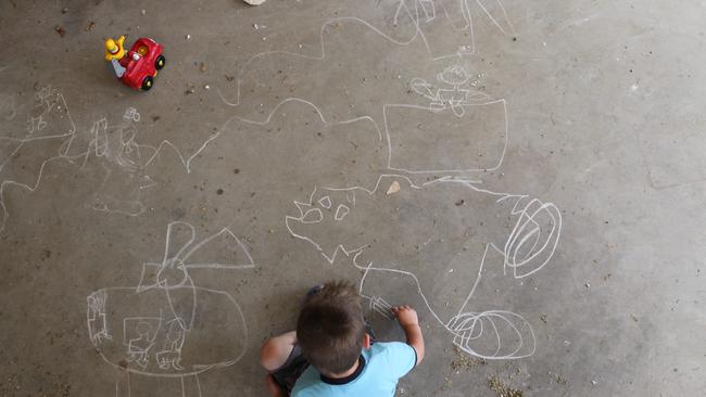 Liam and Lachlan drawing their memories post-floods. Picture: David Kelly