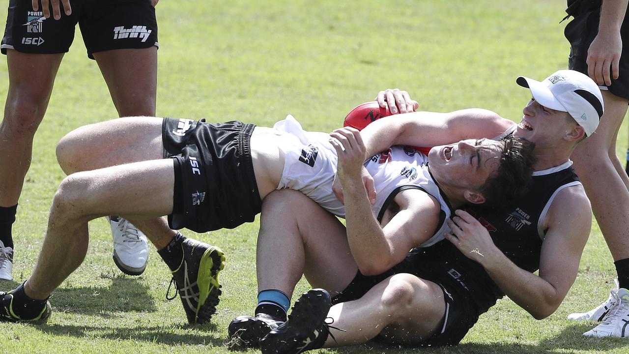 Joe Atley brings down Cameron Hewett at Port Adelaide’s Noosa training camp.