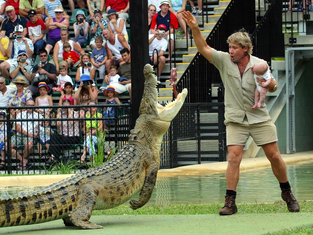Crocodile hunter Steve Irwin holding son Robert in 2004. Picture: The Mega Agency