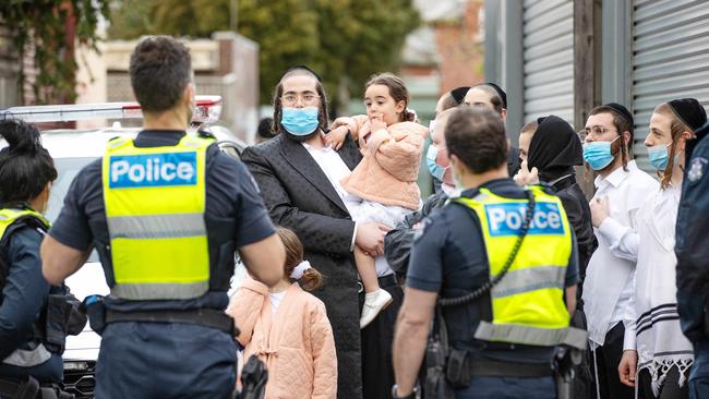 Worshippers speak to police in Melbourne. Picture: Mark Stewart