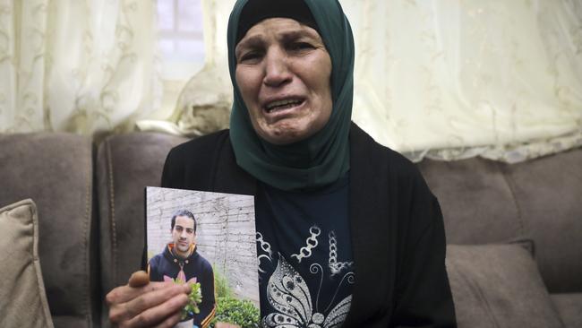 Iyad Halak’s mother Rana holds with a photo of her son. Picture: AP