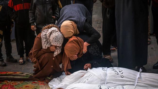 Mourners gather over the bodies of people killed in an Israeli bombardment in the southern Gaza Strip. Picture: AFP/Getty Images