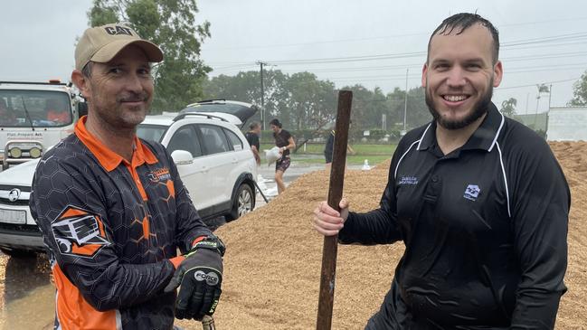 Kurt Sayed (left) from Townsville & Northern Beaches Trailer Hire was one of the first to start filling sandbags at the Mount Low, (right) division 2 councillor Brodie Phillips