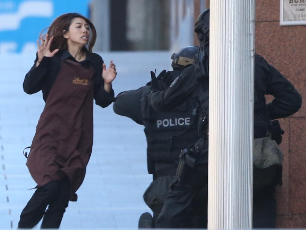 Elly Chen runs towards heavily armed police. Picture: Adam Taylor