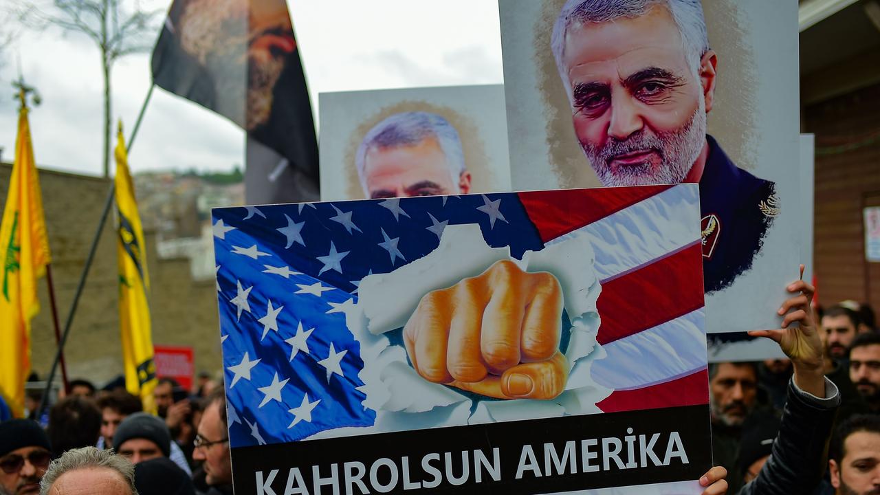 A protester holds a banner reading “down with America”, during a demonstration outside the US consulate in Istanbul, on January 5, 2020, two days after top Iranian commander Qasem Soleimani was killed by a US drone strike. Picture: Yasin Akgul / AFP.