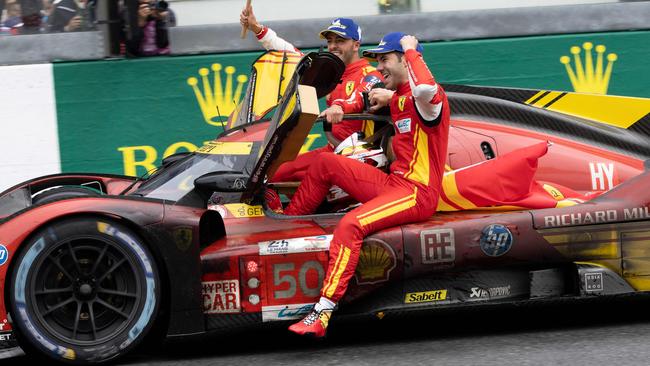 Ferrari 499P Hybrid Hypercar WEC's team, Spanish driver Miguel Molina (R) Italian driver Antonio Fuoco (L) and Danish driver Nicklas Nielsen (driving the car) celebrate after winning Le Mans 24-hours endurance race in Le Mans, western France, on June 16, 2024. Ferrari won a wild and wet 92nd edition of the Le Mans 24 Hours race on June 16, 2024, as Nicklas Nielsen took the chequered flag after a vintage and gruelling race, the Dane sharing driving duties in the Italian constructor's No 50 car with Italian Antonio Fuoco and Spaniard Miguel Molina. (Photo by FRED TANNEAU / AFP)