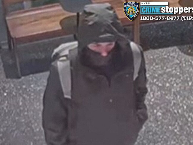 A masked wanted for shooting top US health insurance executive Brian Thompson outside a New York hotel on December 4 in an apparently targeted hit. Picture: AFP